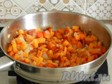 В отдельной сковороде обжарить лук и морковь до золотистого цвета, иногда помешивая, затем добавить болгарской перец и немного обжарить все вместе. Посолить и поперчить.
