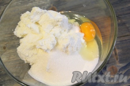 К творогу добавить яйцо и всыпать сахар.