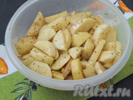 Хорошо перемешать картофель со специями, добавив в миску подсолнечное масло.
