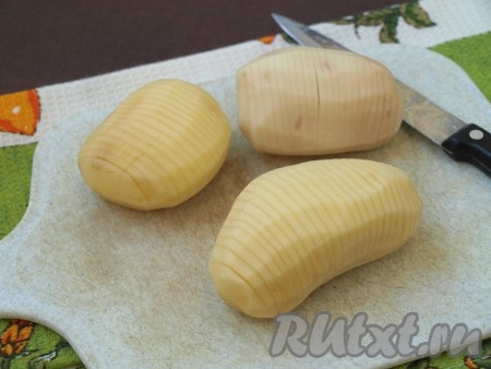 Каждую картошину нарезать гармошкой (как на фото) толщиной 3-4 мм, не дорезая до конца 5-7 мм.
