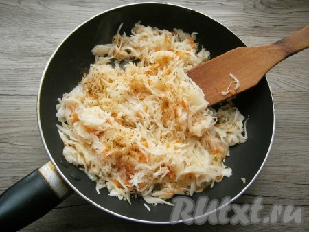 Выложить квашеную капусту в сковороду к обжаренному луку, если нужно, посолить, добавить сахар и специи.