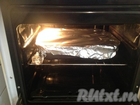 Накрыть противень с куриными бёдрами фольгой и поставить в духовку, разогретую до 200 градусов, на 50 минут.
