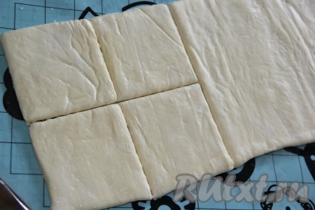 Слоёное тесто разморозить при комнатной температуре. Разрезать тесто на ровные квадратики. Должно получиться чётное количество квадратиков.