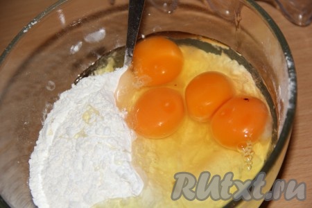 Слегка перемешать сухие ингредиенты ложкой, затем добавить 4 яйца.