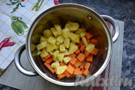 Очистить картофель, чеснок и лук. Очистить от кожуры и семян тыкву. Для приготовления супа потребуется 300 грамм очищенной тыквы. Тыкву и картофель нарезать средними кубиками, поместить в кастрюлю.
