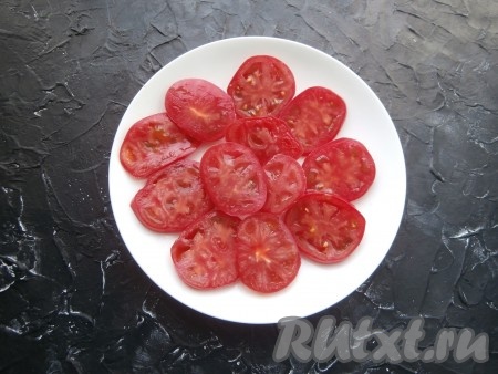 Нарезать свежие крепкие помидоры на кружочки толщиной, примерно, 0,5 см, затем выложить их в один слой на тарелку.