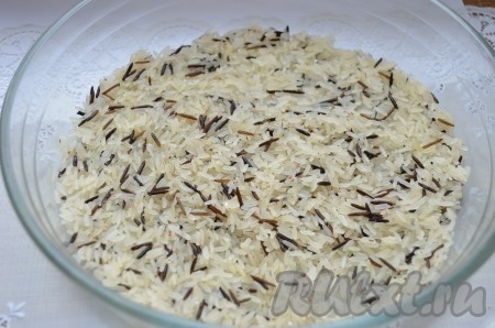 Рис промыть, перемешать с прованскими травами. Выложить в смазанную растительным маслом форму для запекания первым слоем.