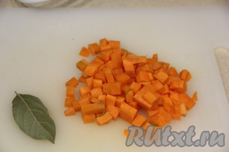 Морковку почистить, нарезать на кубики и вместе с лавровым листом выложить в чашу мультиварки.