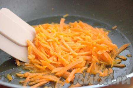 Тем временем вымыть, очистить, натереть на крупной тёрке морковь, переложить её в сковороду с прогретым растительным маслом и обжарить на среднем огне, периодически помешивая, минут 5-7 (до мягкости морковки). 