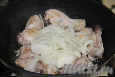 Обжарить курицу со всех сторон в течение 10-15 минут на среднем огне. Лук нарезать на полукольца и выложить в сковороду к обжаренной курице, перемешать.