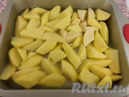 Картофель очистить и нарезать крупными дольками. Выложить в форму для запекания ровным слоем. Залить куриным бульоном.