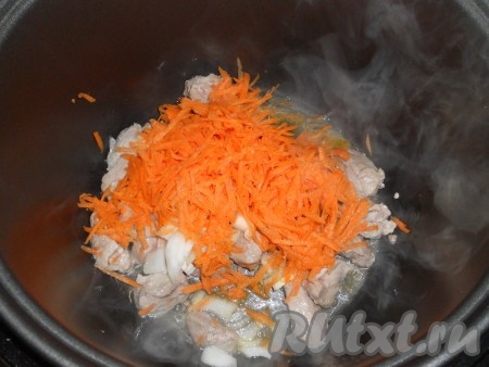 В чашу мультиварки влить подсолнечное масло, выложить мясо. Выставить режим "Жарка" на 10 минут. Затем добавить порезанный репчатый лук и натертую на крупной терке морковь. Готовить на том же режиме еще 10 минут.