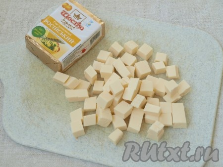 Плавленный сыр нарезаем на небольшие кубики.