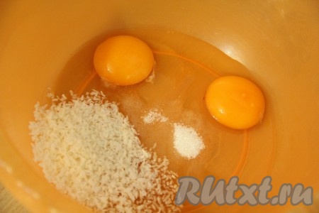В глубокую миску разбить яйца, всыпать кокосовую стружку, сахар, соль, слегка взбить венчиком.