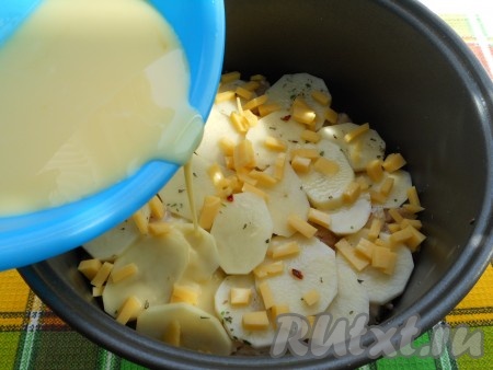 Сверху картофеля в мультиварку выложить натёртый на крупной терке (или нарезанный на маленькие кусочки) твёрдый сыр. Залить яично-молочной смесью картофель с фаршем.