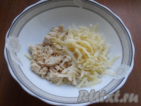Отваренное и охлажденное куриное филе нарезать небольшими кусочками, добавить натертый на крупной терке твердый сыр. 