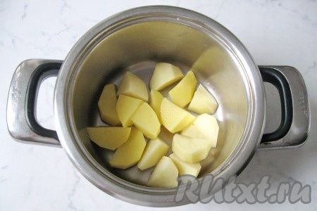 Картофель почистить, помыть и нарезать произвольно. Вообще, размер нарезки овощей для этого супа не имеет значения: все овощи в итоге взбиваются блендером. Выложить картофель в кастрюлю. 