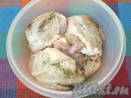 Порционные части курицы (я готовила куриные бедра) вымыть, обсушить, натереть солью и приправами - хмели-сунели и перцем.