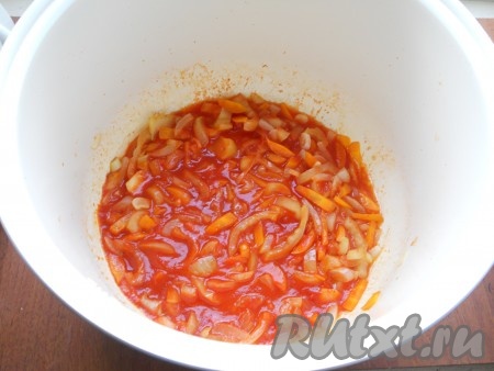 Через 5 минут после начала обжаривания добавить к луку с морковью нарезанный соломкой болгарский перец. Периодически помешивая, обжаривать овощи еще 10 минут. Далее добавить к овощам томатную пасту и влить немного воды, перемешать. Готовить оставшееся время. 
