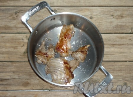Мясо кролика вымыть под холодной проточной водой, обсушить и обжарить до золотистой корочки на сковороде с растительным маслом. Обжаренное мясо сложить в кастрюлю, в которой будем готовить суп. 
