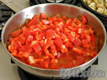 К помидорам добавить нарезанный кубиками болгарский перец, перемешать, всыпать сахар, сладкую и острую паприку и тушить на медленном огне 5-7 минут.