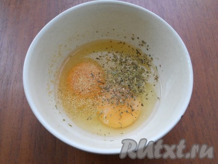 В глубокую тарелку разбить яйца, добавить к ним соль и сухие прованские или итальянские травы, сушеный чеснок (можно использовать измельченный свежий чеснок).
