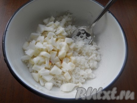 Переложить отваренный рис в миску, добавить нарезанные (предварительно очищенные от семян и кожуры) небольшими кубиками яблоки.
