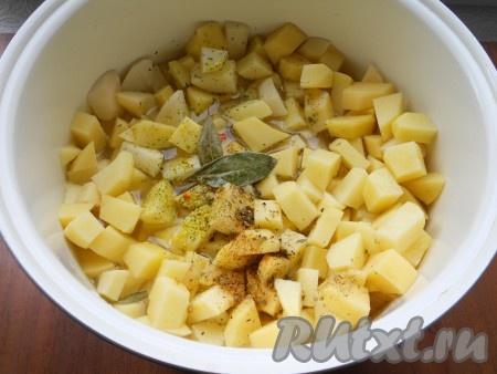 По окончании режима "Жарка" очищенный и нарезанный кубиками картофель добавить к обжаренным овощам в чашу мультиварки. Посолить, всыпать специи, добавить лавровый лист. Влить горячую воду.
