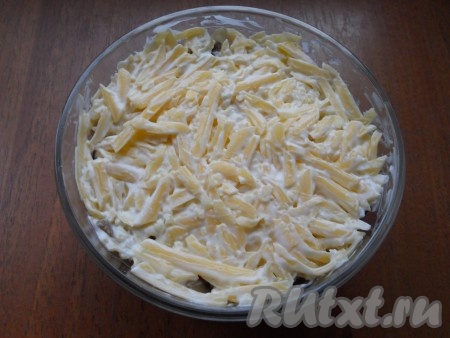 Сыр натереть на терке (средней или крупной) и смешать его с майонезом с чесноком, выложить сыр на грибы последним слоем.
