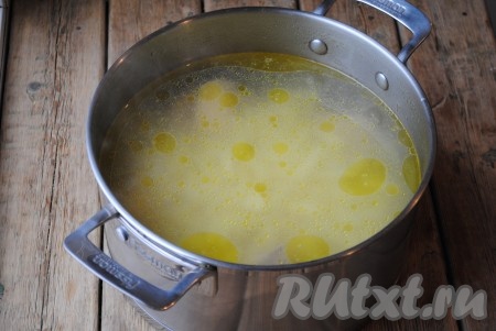 Когда бульон будет готов, его нужно процедить, выложить в него картофель, затем довести до кипения и варить на небольшом огне 10-15 минут. По истечении времени посолить суп. 
