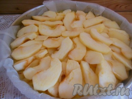 Сверху разложите дольки яблок в три ряда. Выпекайте открытый яблочный пирог в заранее разогретой духовке около 50 минут при температуре 180 градусов. Готовность проверьте при помощи деревянной шпажки - после прокалывания готовой выпечки она должна остаться сухой.