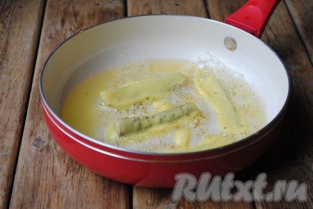 В сковороду налить растительное масло, чтобы оно полностью покрывало дно сковороды. Соленые огурцы обмакнуть в кляр и опустить в разогретое масло. 
