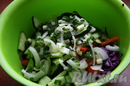 Очищенный репчатый лук нарезать тонкими полу кольцами. Зелёный лук мелко нарезать. Добавить лук в салат из капусты, огурца и перца.
