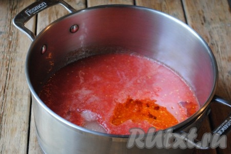 В кастрюлю подходящего объема вылить помидоры, перекрученные с перцем. Добавить сахар, соль и растительное масло. Отправить на плиту, довести до кипения и готовить на небольшом огне 10 минут. 
