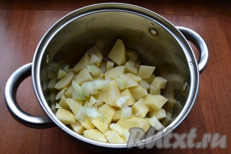 Картошку, лук и морковь очистить. Болгарский перец освободить от семян. Картофель нарезать в кастрюлю кубиками, добавить нарезанный репчатый лук.
