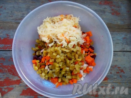 Выложите нарезанные овощи в глубокую миску, добавьте квашеную капусту. Слегка посолите, учитывая, что огурцы и квашеная капуста уже соленые.