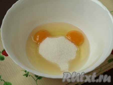 В другую миску разбить яйца, добавить сахар и затем хорошо взбить.