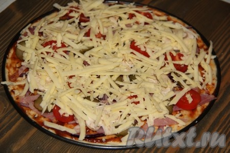 Далее добавить оливки и посыпать пиццу сыром.

