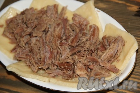 На плоскую тарелку выложить готовую лапшу, на лапшу выложить мясо.