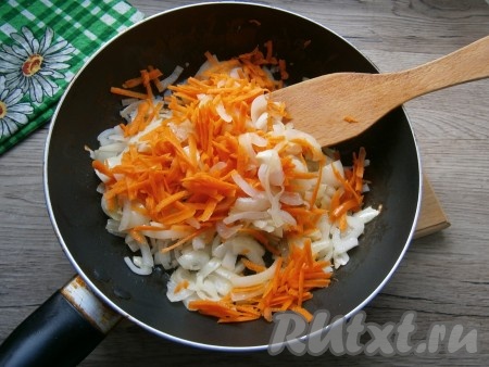 Добавить к луку очищенную и натертую на крупной терке морковь. Обжаривать овощи вместе, помешивая, еще 5-6 минут, после чего переложить в миску и дать остыть.
