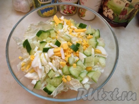 Сложить капусту в салатник, туда же добавить нарезанные огурец и яйца.
