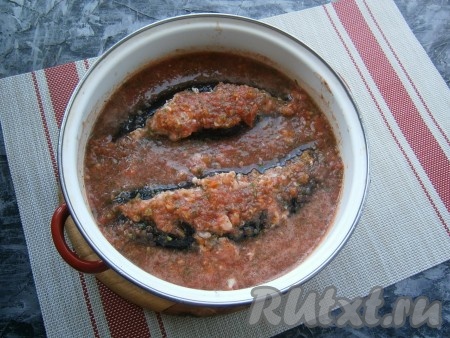 Поместить фаршированные баклажаны в кастрюлю с толстым дном (или в сотейник), залить соусом.
