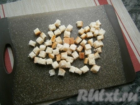 Нарезать белый хлеб (или батон) на небольшие кубики (для приготовления сухариков в СВЧ хлеб должен быть мягким).
