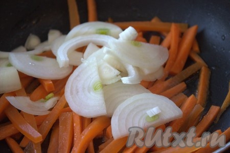 На другой сковороде, разогретой с растительным маслом, на среднем огне в течение 1-2 минут обжарить, помешивая, нарезанную соломкой морковь. Затем в сковороду к морковке добавить очищенный и нарезанный тонкими полукольцами репчатый лук, перемешать.