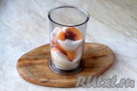Персики без косточек отправьте в чашу блендера и добавьте сахарный песок. 
