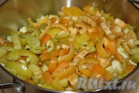Вымыть болгарский перец, удалить из него плодоножки с семенами, а затем нарезать на широкие полоски. Выложить перец в кастрюлю к кабачкам.
