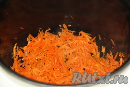 В чашу мультиварки влить немного растительного масла, выложить морковку, предварительной очищенную и натёртую на крупной тёрке, и включить режим "Жарка".
