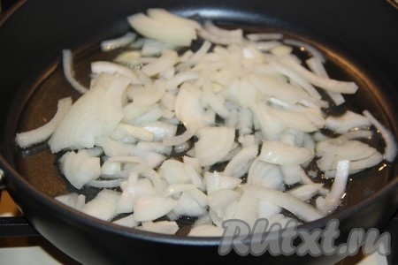 В сковороду с высокими бортиками влить растительное масло, выложить лук и на среднем огне обжарить, помешивая, в течение 3 минут. 