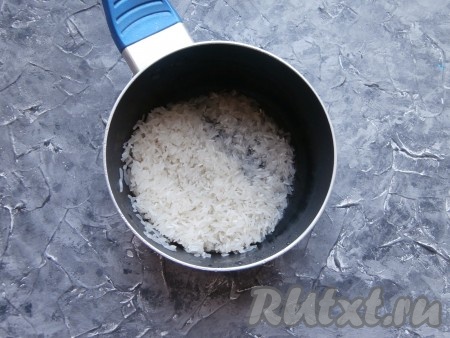 Длиннозернистый рис промыть несколько раз проточной водой, дать стечь воде, а после этого поместить в небольшую кастрюльку.
