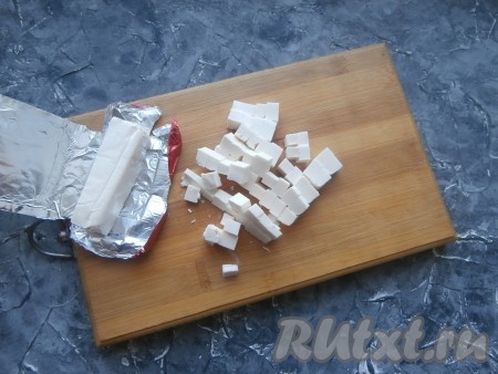Охлаждённый плавленный сыр нарезать на небольшие кубики.